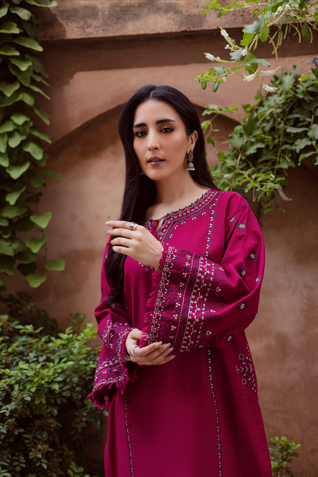 Deep pink khaddar shirt by Batik detailed with intricate cross stitch embroidery and thread tassels. Affordable ethnic Pakistani South Asian.