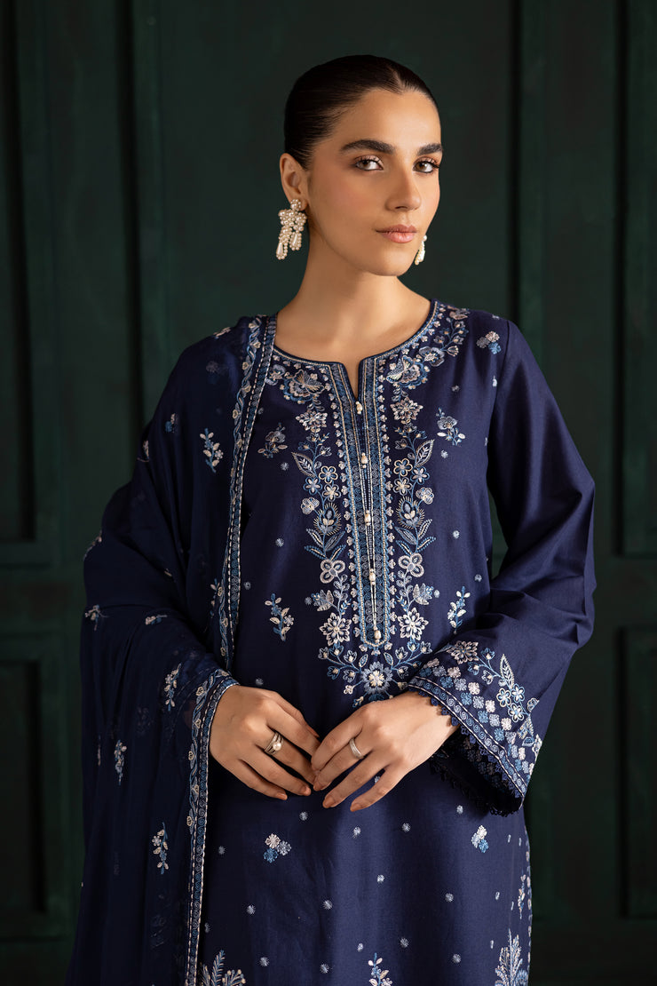 Blue khaddar shirt by Batik adorned with detailed embroidery and crochet lace for an elegant festive look. Affordable ethnic Pakistani South Asian.