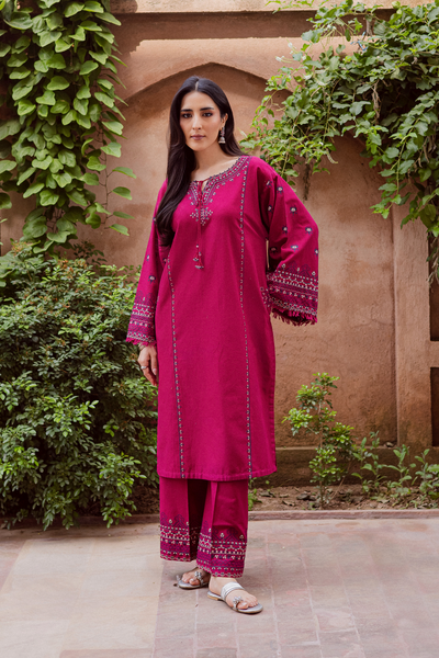Batik Crossword two piece khaddar set featuring a deep pink embroidered shirt with tassel accents and fringed sleeves. Affordable ethnic Pakistani South Asian