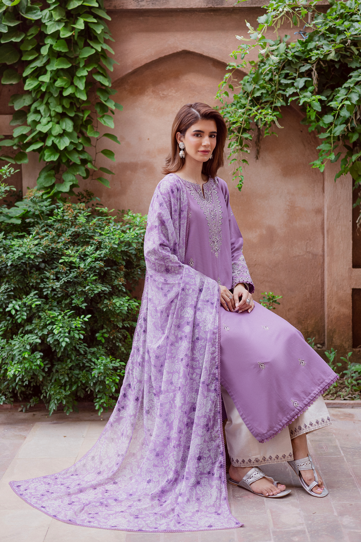 Three piece khaddar ensemble in lavender showcasing intricate embroidery and timeless sophistication. Ready to wear Pakistani South Asian.