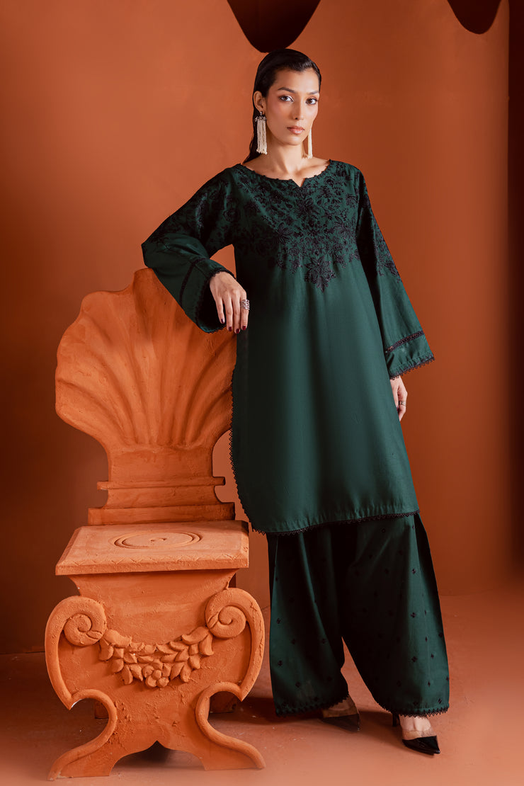 Two piece Batik khaddar ensemble featuring hand embellished sleeves and minimal embroidered shalwar. Affordable ethnic Pakistani South Asian.