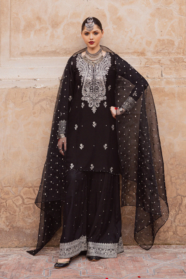 Arbish three piece black raw silk set featuring an embroidered short paneled shirt with crystal detailing. Festive luxury Pakistani South Asian.