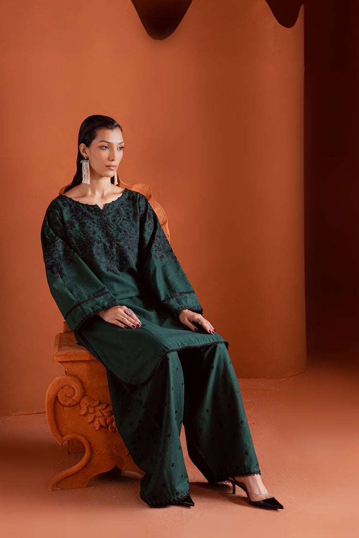 Two piece Batik khaddar ensemble featuring hand embellished sleeves and minimal embroidered shalwar. Affordable ethnic Pakistani South Asian.