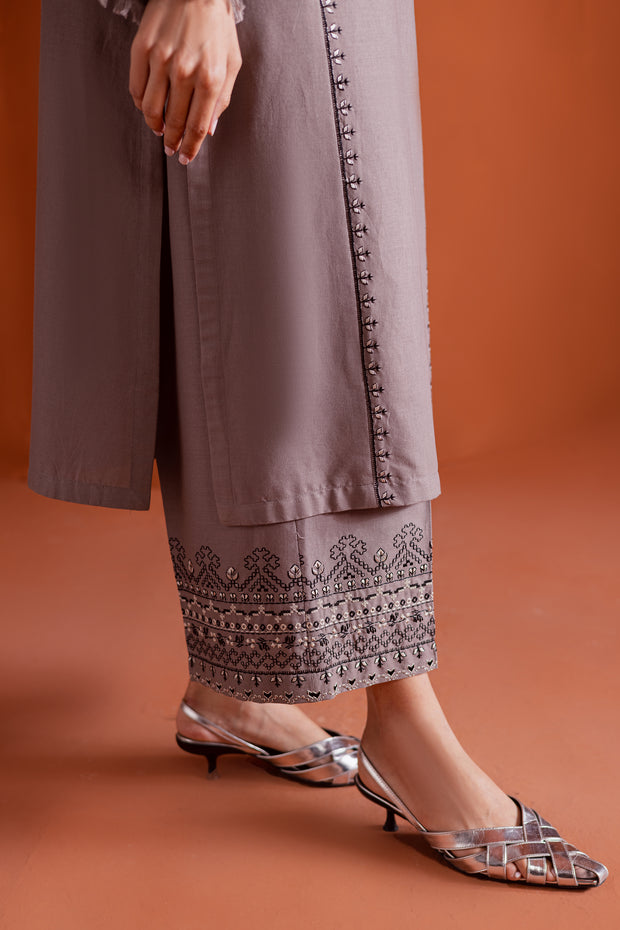 Crossword khaddar outfit detailed with thread tassels and delicate embroidery for timeless charm. Ready to wear Pakistani South Asian