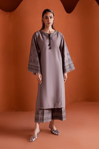 Crossword two piece khaddar set featuring a grey paneled shirt with cross stitch embroidery and tassel detailing. Ready to wear Pakistani South Asian