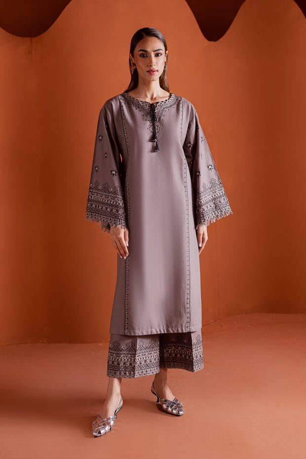 Crossword two piece khaddar set featuring a grey paneled shirt with cross stitch embroidery and tassel detailing. Ready to wear Pakistani South Asian