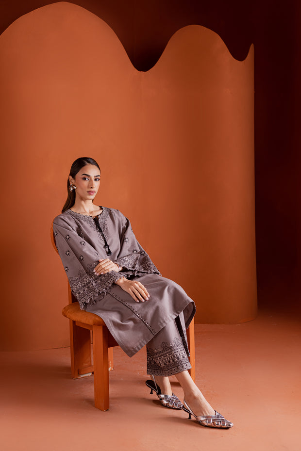 Embroidered grey khaddar ensemble with fringed sleeve borders and contemporary silhouette. Ready to wear Pakistani South Asian