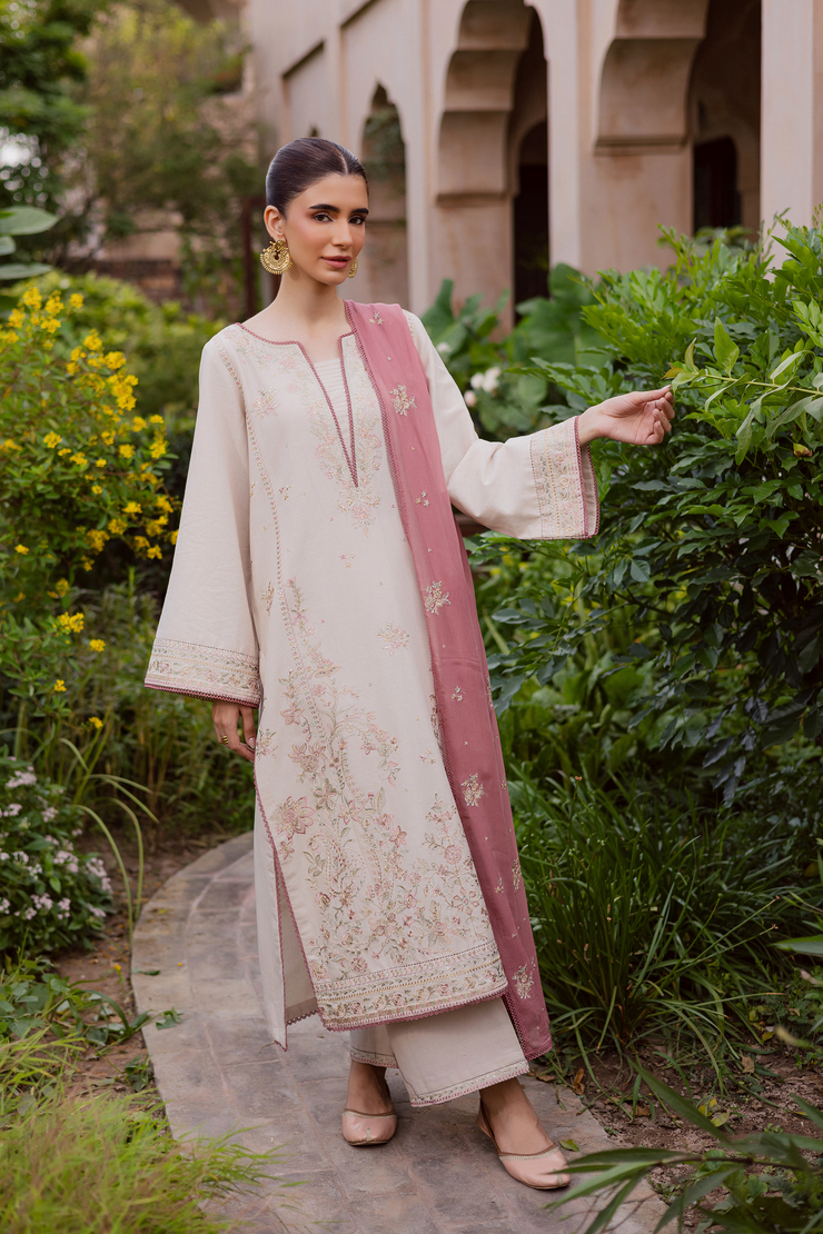 Three piece khaddar outfit combining a richly embroidered shirt, culottes, and pink dupatta. Ready to wear Pakistani South Asian.