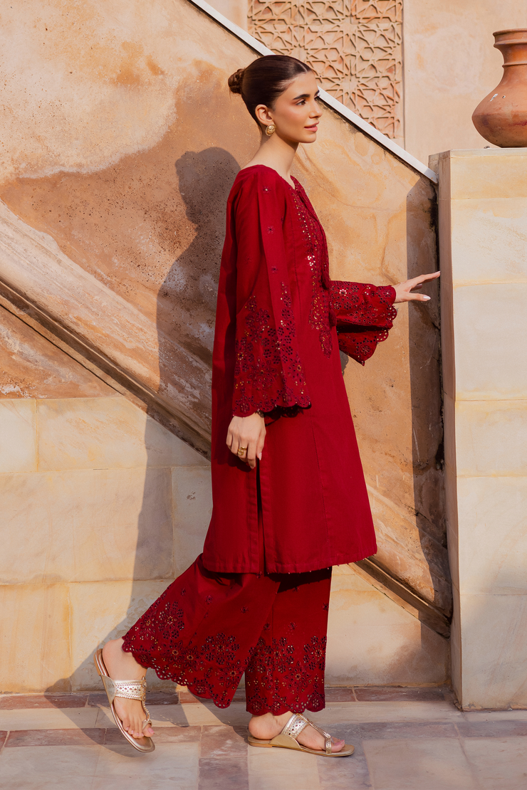 Embroidered red khaddar shirt paired with matching culottes featuring kabua finishing. Ready to wear Pakistani South Asian.