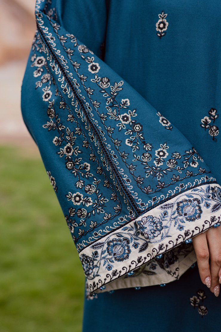 Blue khaddar outfit showcasing graceful craftsmanship and contemporary design. Ready to wear Pakistani South Asian affordable
