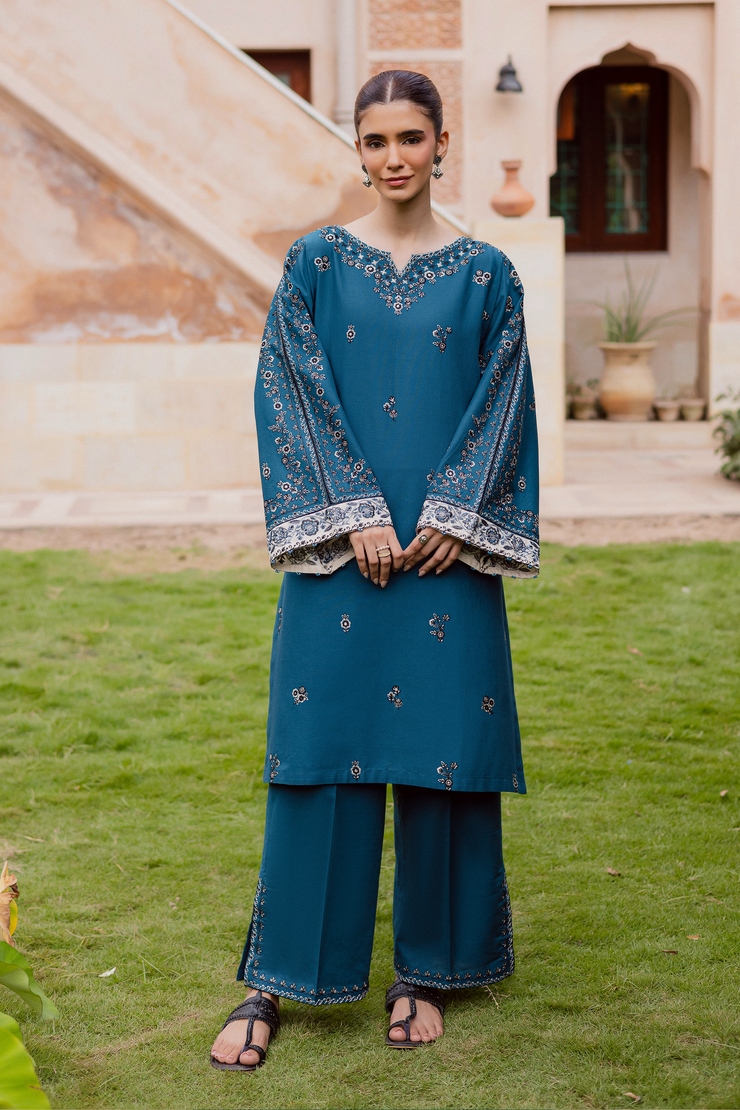 Khaddar outfit in deep blue tones with detailed embroidery and sparkling crystal work. Ready to wear Pakistani South Asian.