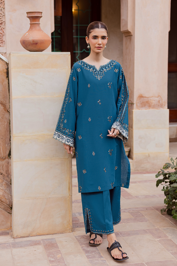 Two piece embroidered khaddar set in teal blue featuring a refined kurta fit shirt with crystal detailing and lace accents. Ready to wear Pakistani South Asian.