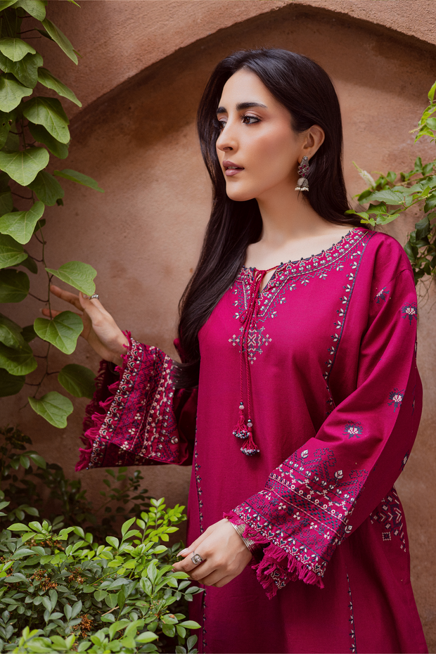 Two piece Batik khaddar ensemble with cross stitch embroidery and delicate lace finishing. Affordable ethnic Pakistani South Asian.