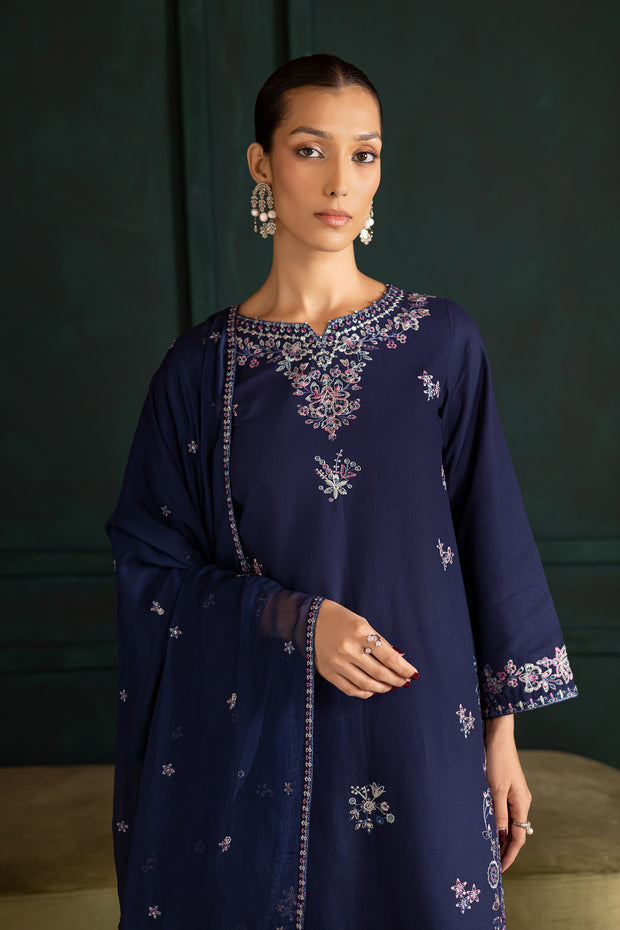 Front view of Dusky khaddar outfit with intricate tilla and colorful embroidery adding depth and charm. Ready to wear Pakistani South Asian.
