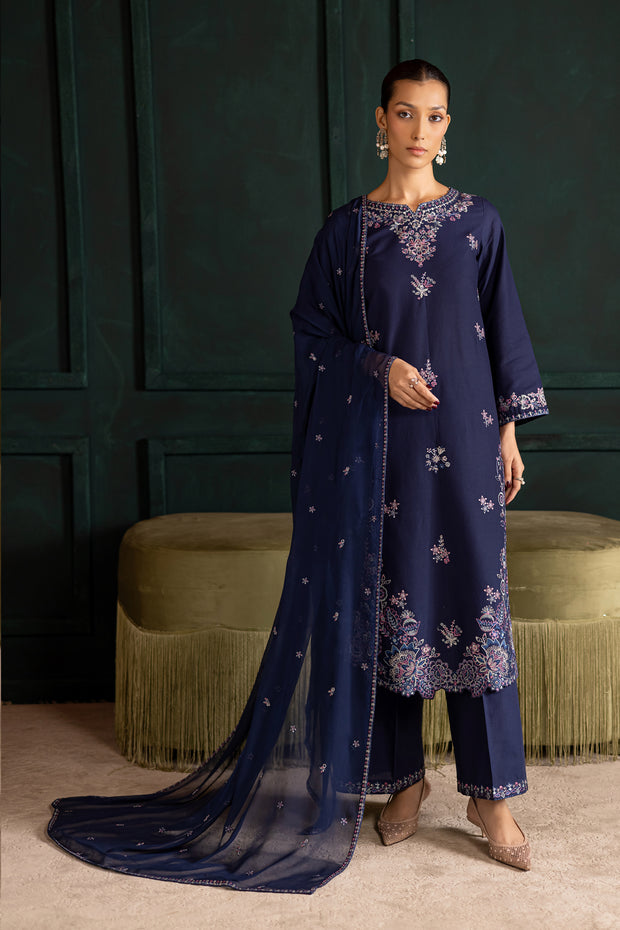 Dusky three piece khaddar set featuring a long embroidered blue shirt with matching trousers and dupatta. Ready to wear Pakistani South Asian