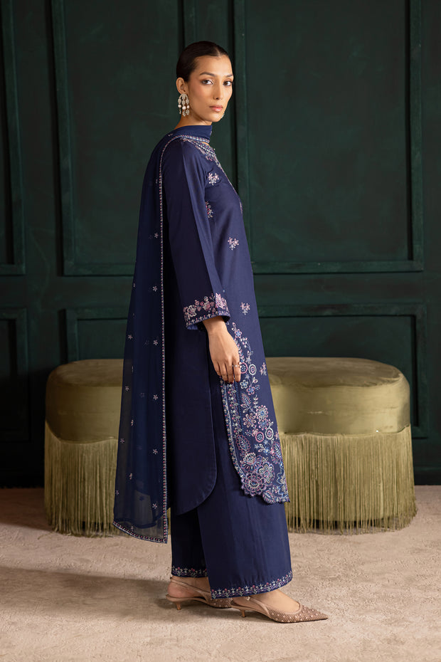 Side view of Dusky embroidered khaddar outfit featuring sleek matching trousers. Ready to wear Pakistani South Asian fashion.