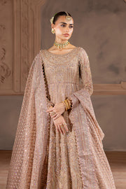 Front pose of model wearing heavily embroidered bridal ensemble in soft pink hues, exuding classic South Asian grace. Bridal luxury Pakistani South Asian Indian.