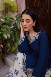 Two piece khaddar ensemble with scalloped embroidered borders and pearl details for graceful everyday elegance. Ready to wear Pakistani South Asian.