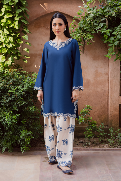 Two piece khaddar set featuring a short blue straight shirt with embroidered keyhole neckline and scalloped borders. Ready to wear Pakistani South Asian.