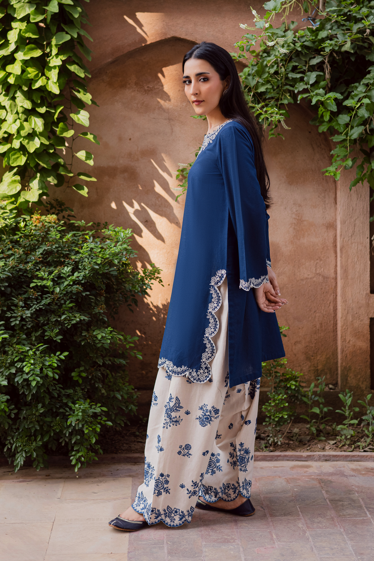 Embroidered contrasting shalwar with all over motifs and scalloped hem paired with blue khaddar shirt. Ready to wear Pakistani South Asian.
