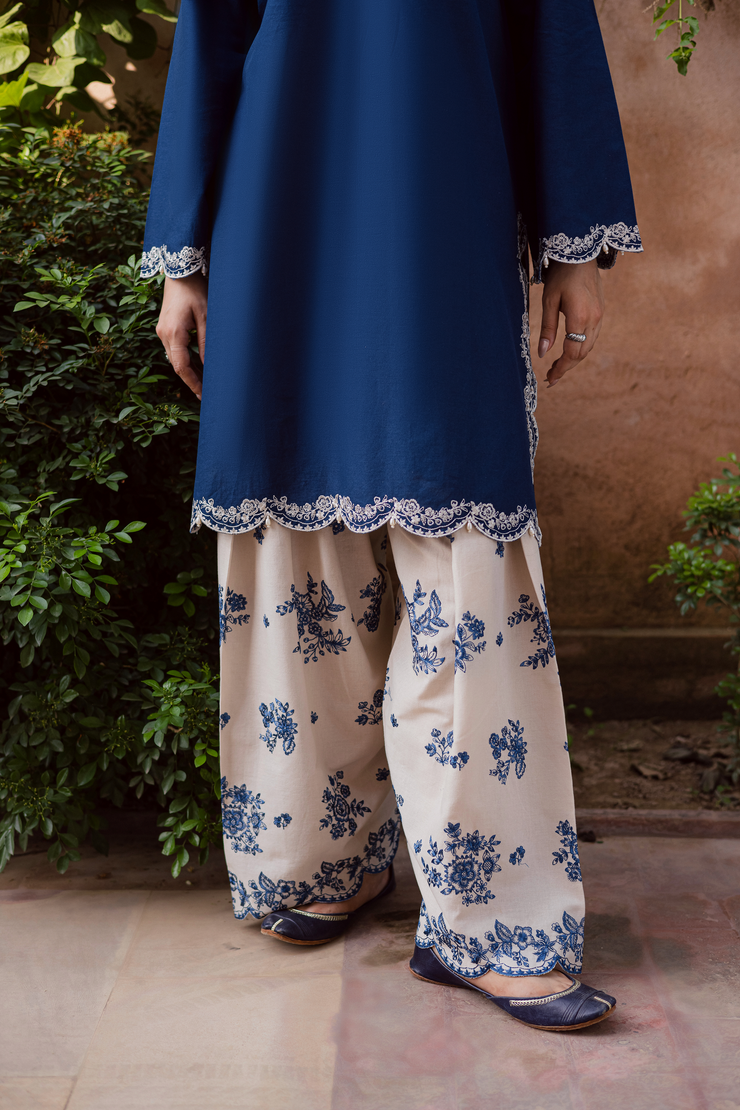 Contemporary blue khaddar outfit blending soft embroidery, pearl accents, and refined tailoring. Ready to wear Pakistani South Asian