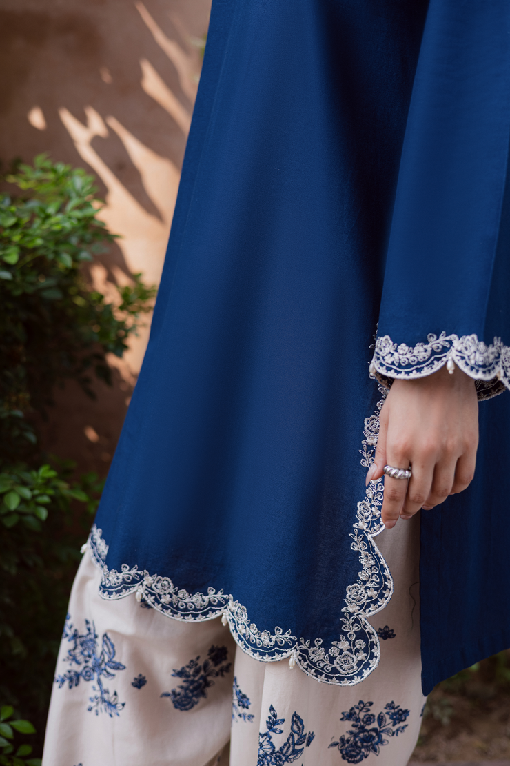 Embroidered blue khaddar two piece set showcasing intricate scalloped edges and balanced modern style. Ready to wear Pakistani South Asia