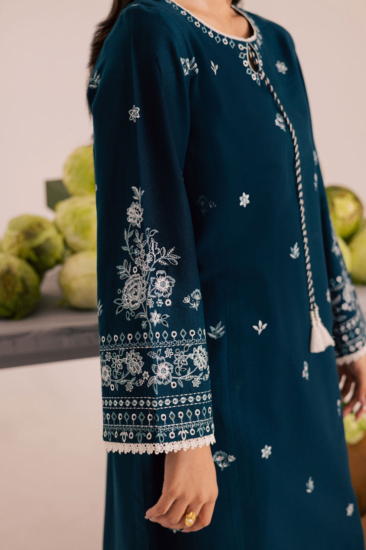 Elegant ocean blue khaddar outfit featuring embroidered sleeves and refined craftsmanship. Ready to wear Pakistani South Asian.